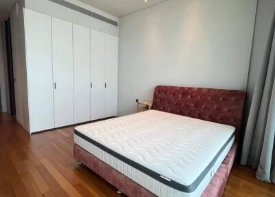 Spacious bedroom with a large bed and built-in wardrobes