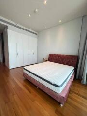 Spacious bedroom with a large bed and built-in wardrobes