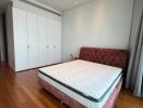 Spacious bedroom with a large bed and built-in wardrobes