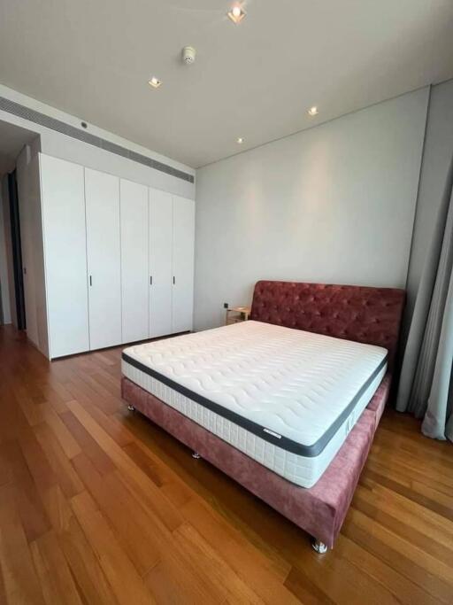 Spacious bedroom with a large bed and built-in wardrobes