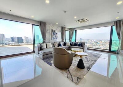 Modern living room with large windows and city view