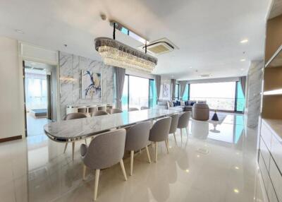 Spacious, modern living and dining area with large windows and contemporary decor