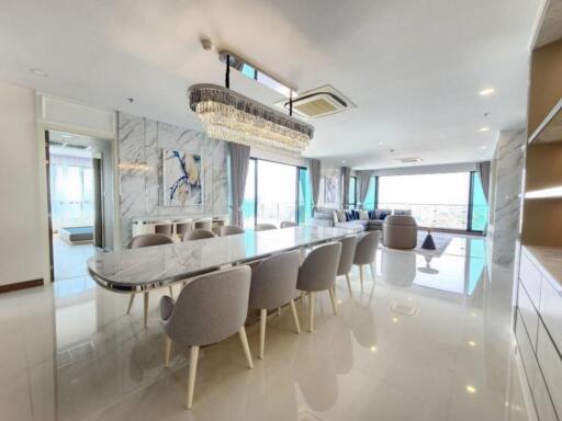 Spacious, modern living and dining area with large windows and contemporary decor