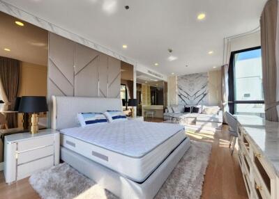 Spacious bedroom with modern decor and ample natural light