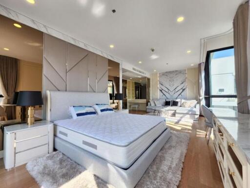 Spacious bedroom with modern decor and ample natural light