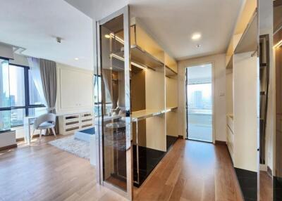 Modern bedroom with ample natural light and a walk-in closet