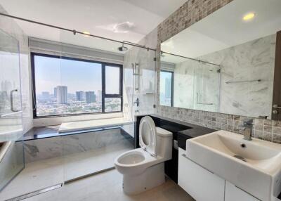 Modern bathroom with large window and city view