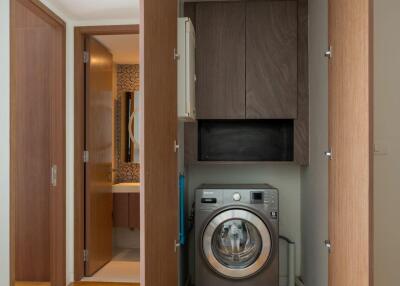 Compact laundry area with washing machine and storage cabinets