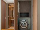 Compact laundry area with washing machine and storage cabinets