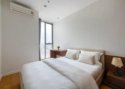 Modern bedroom with double bed, window, and air conditioning