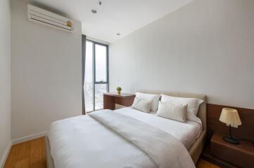 Modern bedroom with double bed, window, and air conditioning