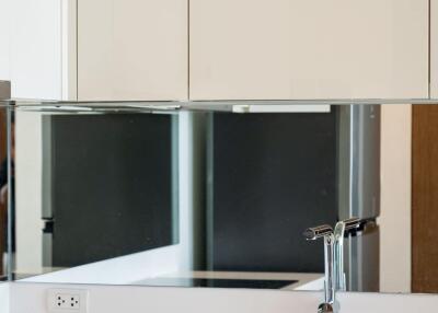 Bright modern kitchen with white cabinets and stainless steel fixtures