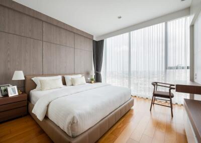 Modern bedroom with a large window and wooden floor