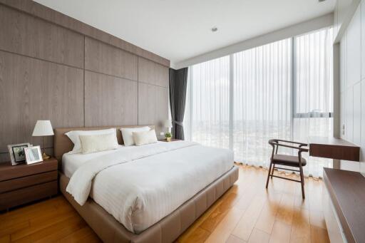 Modern bedroom with a large window and wooden floor