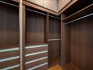 Spacious walk-in closet with wooden cabinetry and built-in shelves