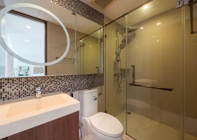 Modern bathroom with glass-enclosed shower and vanity