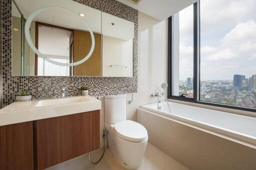 Modern bathroom with large window and city view