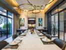 Elegant dining room with a large table set for dinner and modern chandeliers