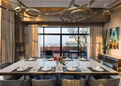 Elegant dining room with modern chandelier and large windows