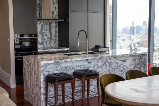 Modern kitchen with marble countertops and city view