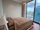 High-rise apartment bedroom with city view