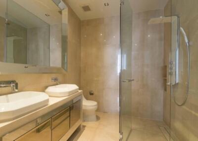 Modern bathroom with double sinks and glass shower