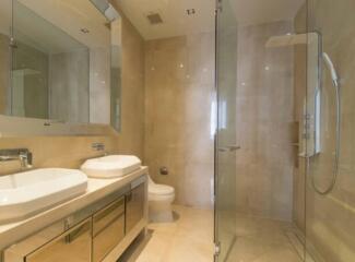 Modern bathroom with double sinks and glass shower