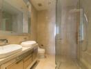 Modern bathroom with double sinks and glass shower