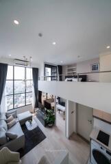 Modern duplex living room with large windows and high ceilings