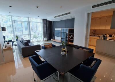 Spacious modern living room with dining area and view of the city