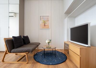 Modern living room with a sofa, TV, and coffee table