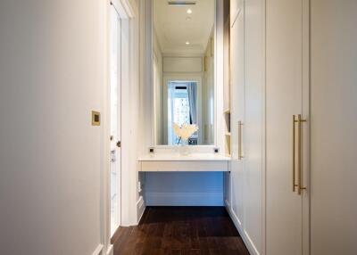 Modern bathroom with white cabinetry and large mirror