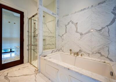 Luxurious bathroom with marble tiles and bathtub