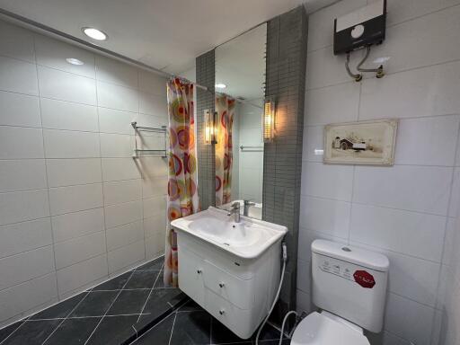 Bathroom with sink, toilet, and shower