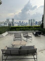 Scenic view of city from outdoor terrace with seating