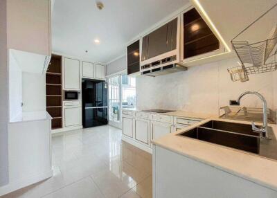 Modern kitchen with white cabinets and stainless steel appliances