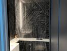 Modern bathroom with black marble tiles