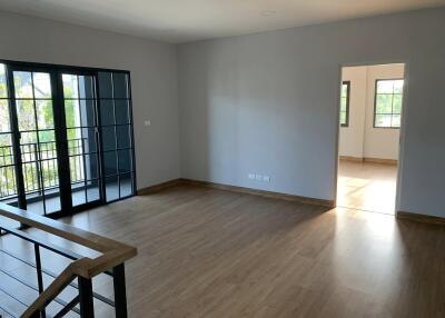 Living room with wooden floor and large windows