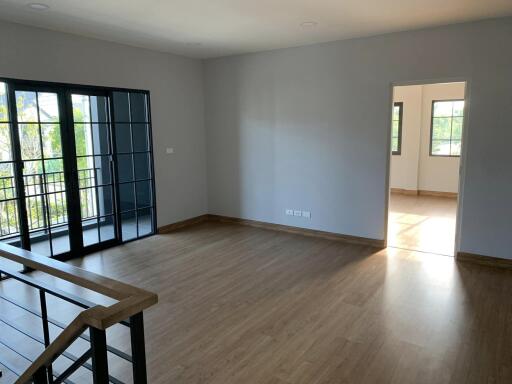 Living room with wooden floor and large windows