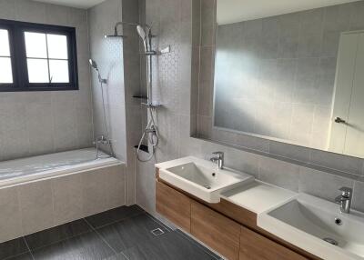 Modern bathroom with double sinks and a bathtub