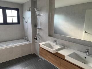 Modern bathroom with double sinks and a bathtub