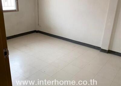 Empty bedroom with tiled floor and window