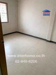 Empty bedroom with tiled floor and window