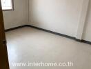 Empty bedroom with tiled floor and window