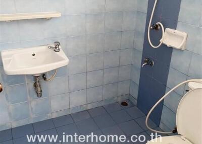 Bathroom with blue tiles and basic fixtures