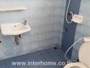 Bathroom with blue tiles and basic fixtures