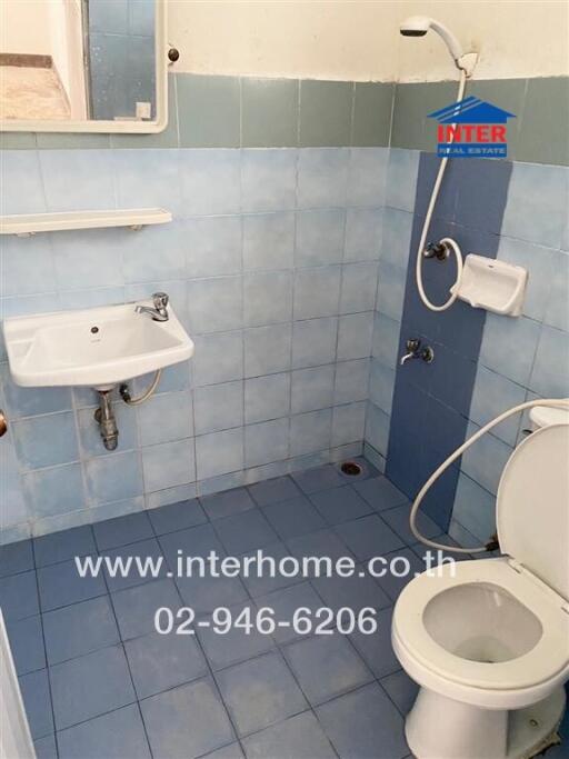 Bathroom with blue tiles and basic fixtures