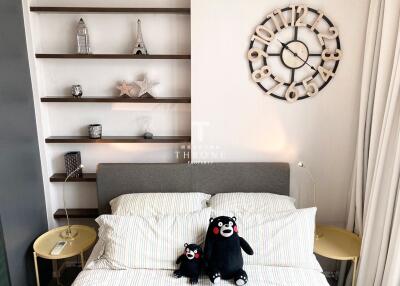 Modern bedroom with shelves and decorative wall clock