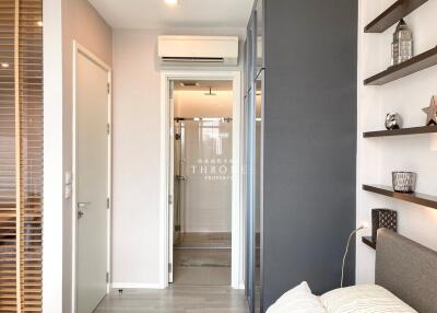 Modern bedroom with bathroom view and decorative shelving