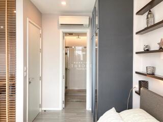 Modern bedroom with bathroom view and decorative shelving